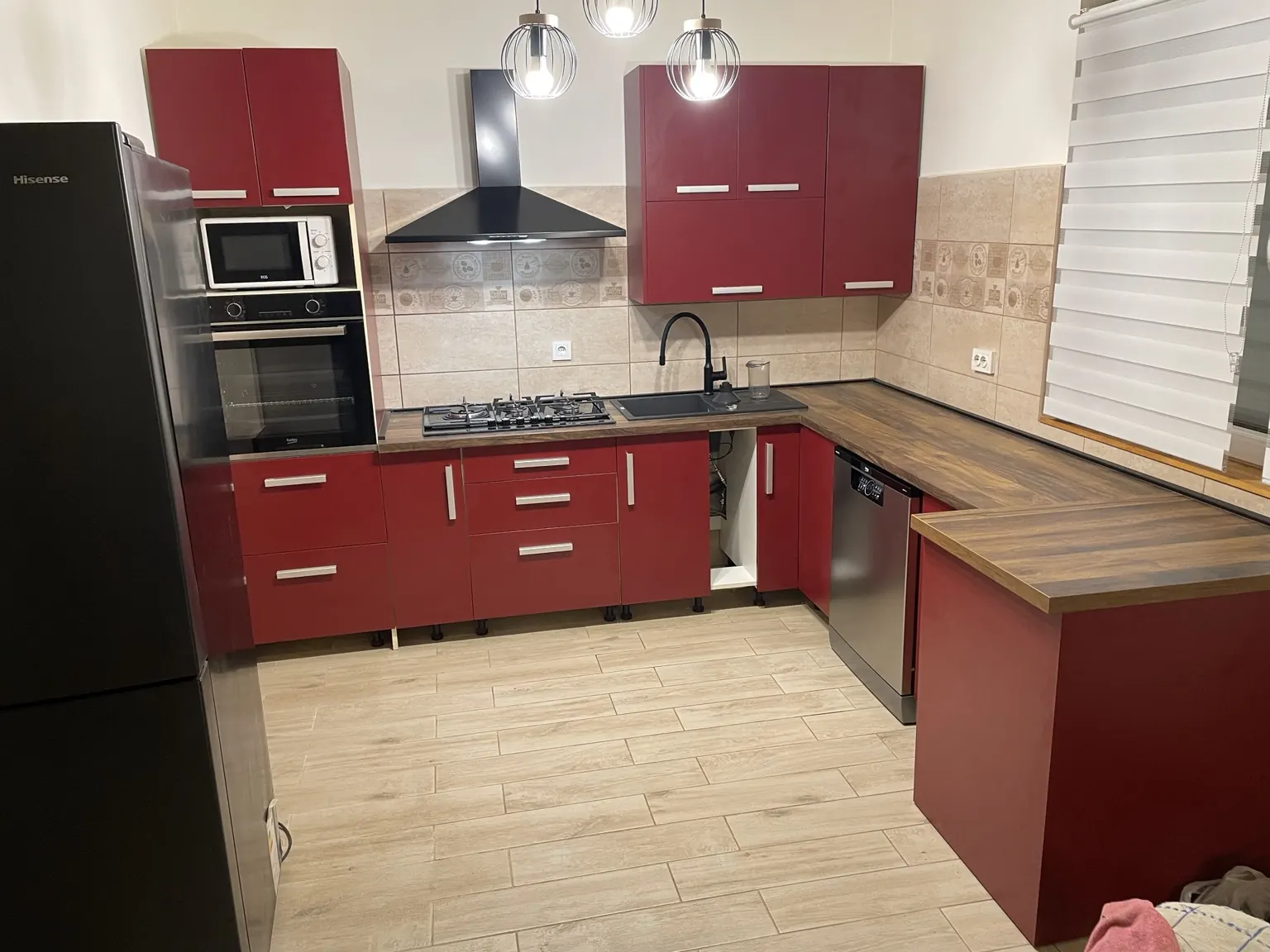 Završno montirana kuhinja s novom radnom pločom, sudoperom, baterijom i kuhinjskim uređajima.